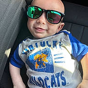 Randy joined the competition — help win amazing prizes! baby, child, sunglasses, smile, shirt, blue, white, car_seat, reflection, sunlight, casual, portrait, young_child, clothing, seat, cute, relaxed, person, indoor, fashion