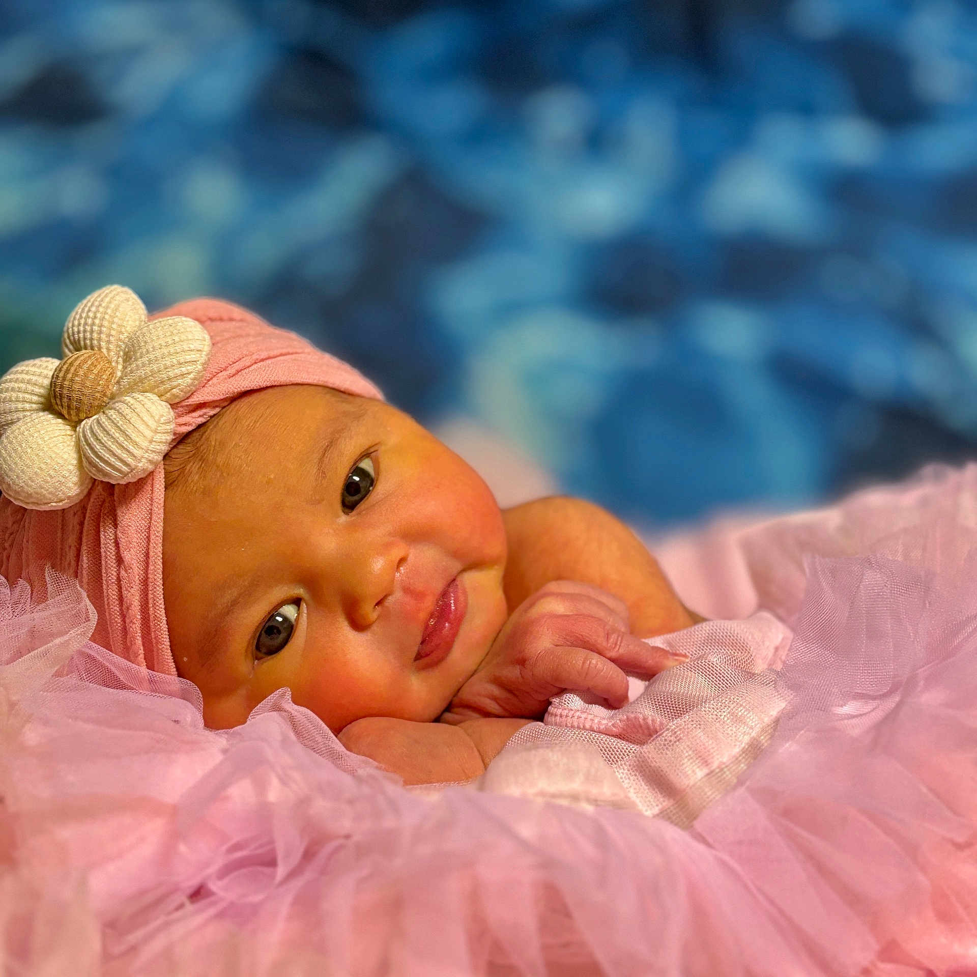 Juniper is registered to the contest to win money with this photo: baby, background, blur, child, closeup, cute, eyes, fabric, face, flower, hand, headwrap, infant, newborn, pink, portrait, skin, smile, soft, tutu