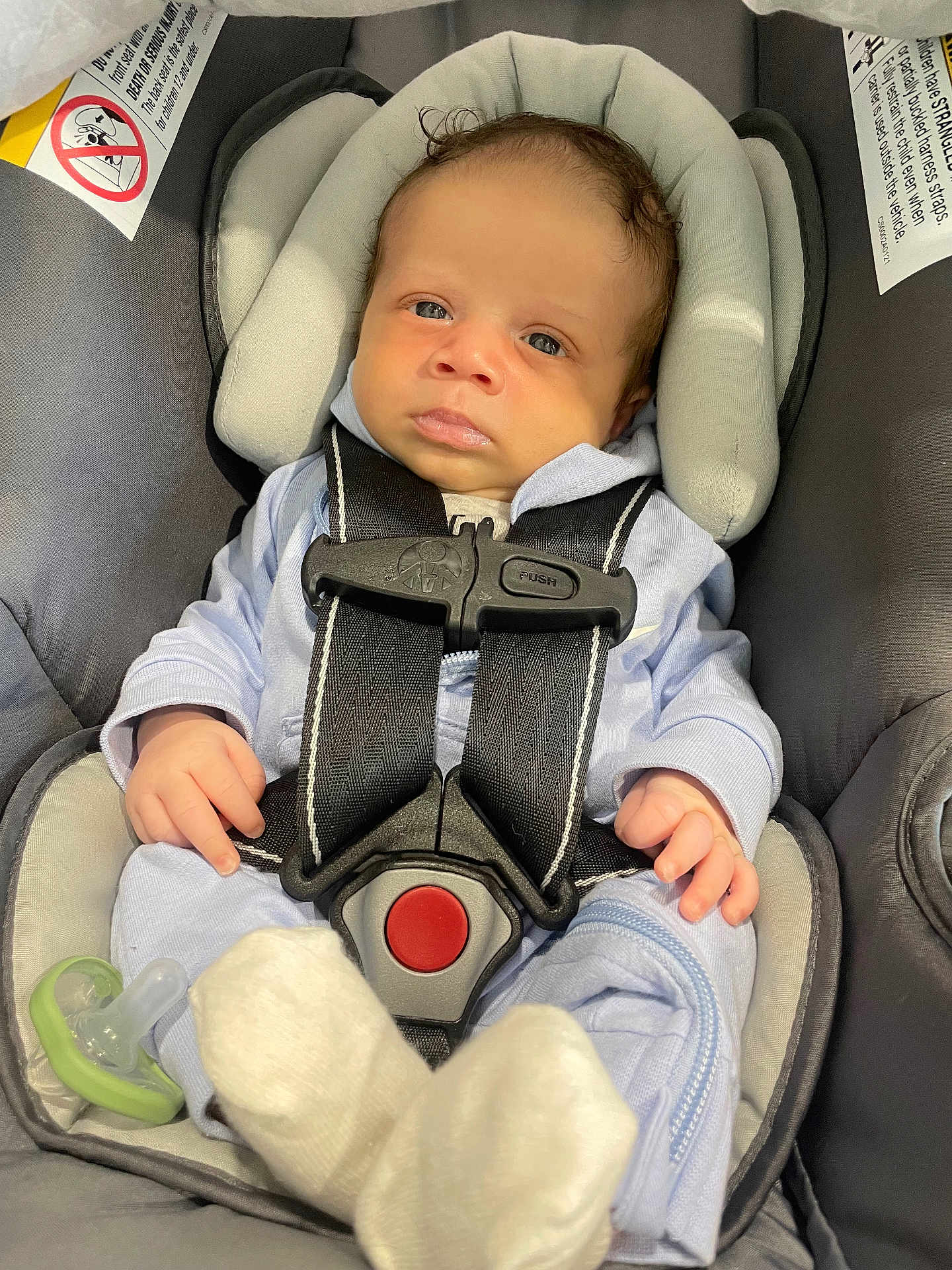 Treyton is registered to the contest to win money with this photo: baby, infant, car_seat, baby_clothing, pacifier, straps, safety, cute, newborn, child, seat_belt, soft_fabric, small_hands, head_support, indoor, closeup, portrait, child_seat, baby_sock, baby_gear
