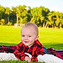 Christopher joined the competition — help win amazing prizes! baby, blanket, casual_clothing, child, cute, daylight, face, field, grass, greenery, happy, infant, nature, outdoor, portrait, red_shirt, relaxed, smiling, trees, young_child