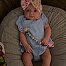 Keely is registered to the contest to win money with this photo: baby, infant, blue_outfit, headband, bow, pacifier_chain, cushion, polka_dot, white_booties, indoor, cute, child, person, relaxing, small_hands, small_feet, looking_up, seated, soft_lighting, adorable