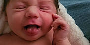 Milani joined the competition — help win amazing prizes! baby, tongue, face, hair, hand, blanket, skin, expression, infant, cute, newborn, sleepy, cozy, wrinkled_skin, tongue_out, closed_eyes, soft_texture, denim, funny_face, portrait