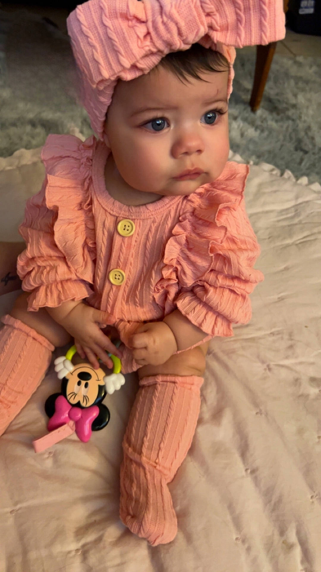 Everleigh is registered to the contest to win money with this photo: baby, bodypart, bonnet, cap, clothing, costume, couch, doll, dress, face, finger, hand, hat, head, pants, person, photography, portrait, sitting, toy