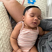 Skylar is registered to the contest to win money with this photo: baby, sleeping, infant, onesie, pink_stripes, pillow, soft_texture, cuddling, peaceful, cute, child, person, skin, arm, hand, closed_eyes, rest, comfort, indoors, relaxation