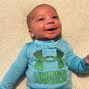 Mateo joined the competition — help win amazing prizes! baby, infant, smiling, blue_clothing, onesie, under_armour, happy, face, head, lying_down, blanket, soft_texture, cute, child, human, portrait, skin, young, casual, indoor