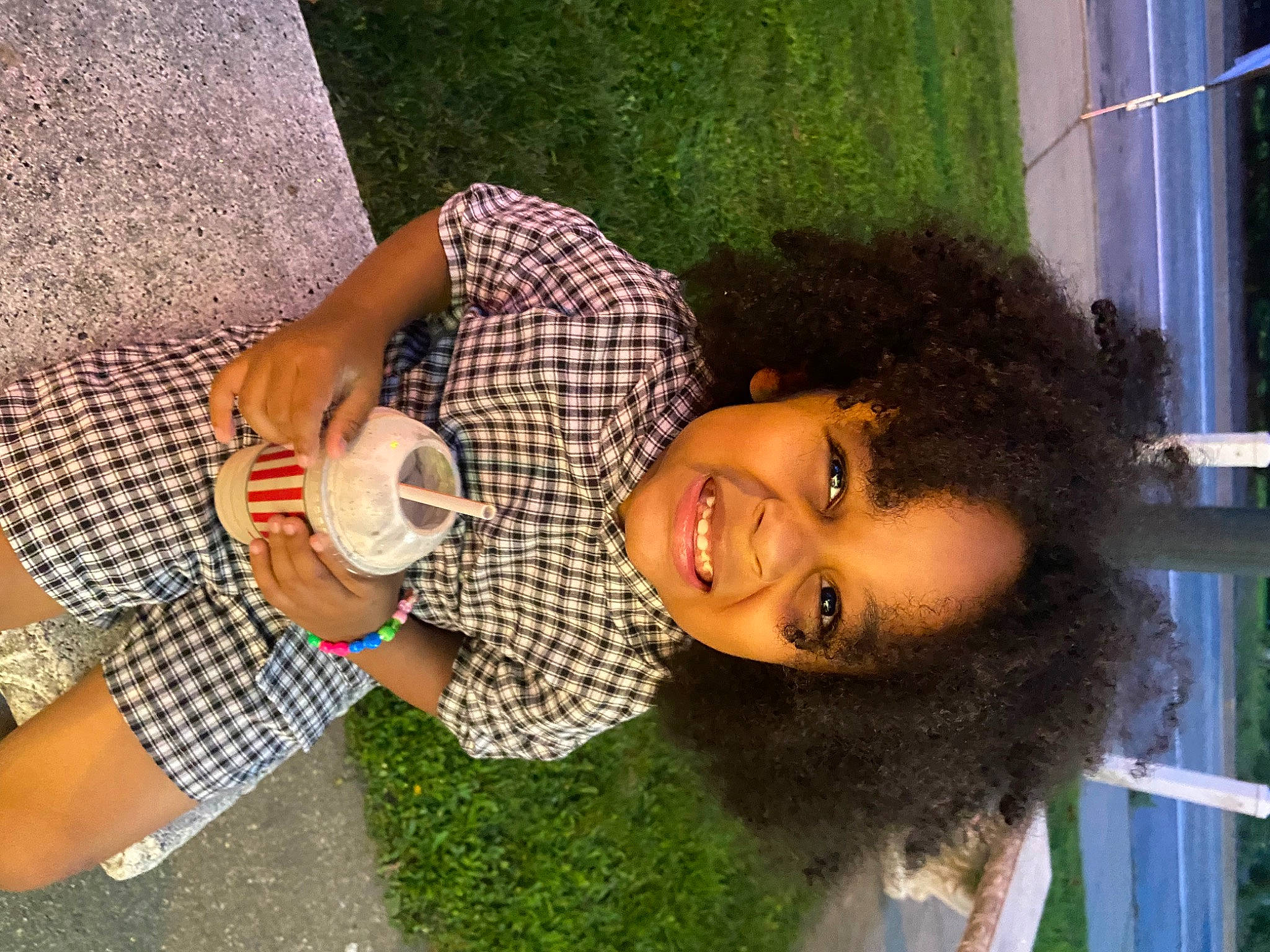 Kendal is registered to the contest to win money with this photo: afro, beer, black_hair, child, drinking, food, fun, grass, green, happy, human_leg, joy, knee, leisure, nail, pattern, person, smile, thigh, thumb