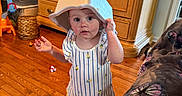 Vivian joined the competition — help win amazing prizes! toddler, child, indoor, wooden_floor, cabinet, toy, plastic_container, shirt, shorts, barefoot, blanket, butterfly_pattern, curious, standing, home, furniture, playful, person, face, expression
