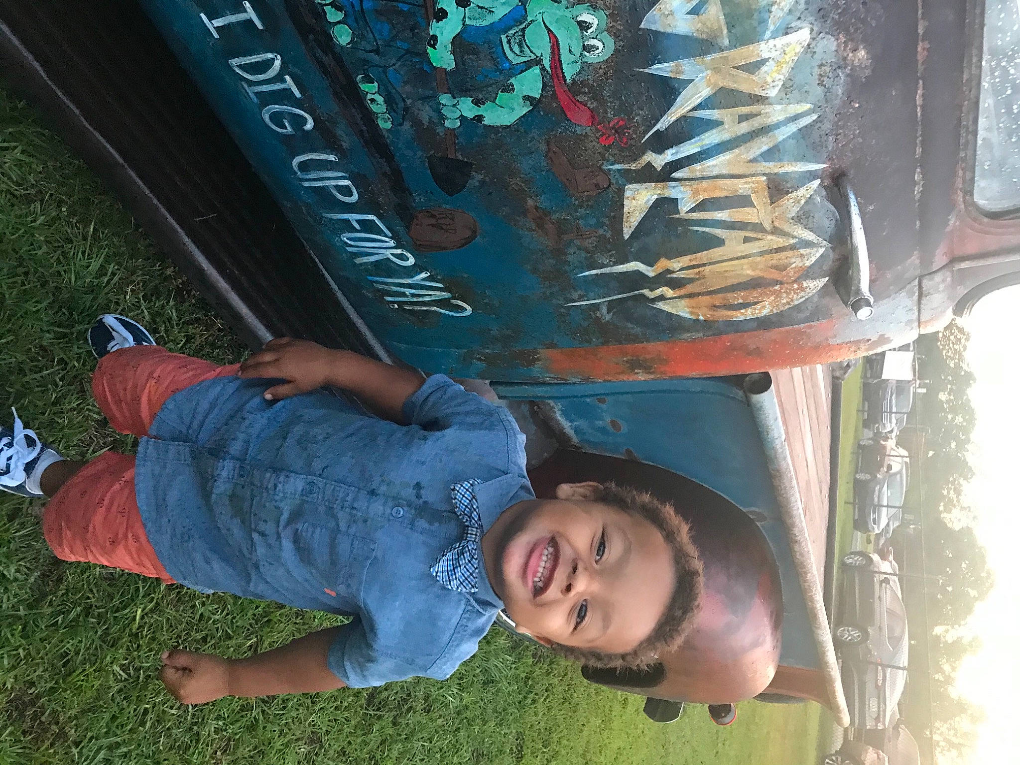 Bryant is registered to the contest to win money with this photo: automotive_wheel_system, baby_toddler_clothing, black, bumper, child, cool, denim, electric_blue, flooring, fun, grass, happy, joy, leisure, person, photograph, sky, smile, snapshot, t_shirt