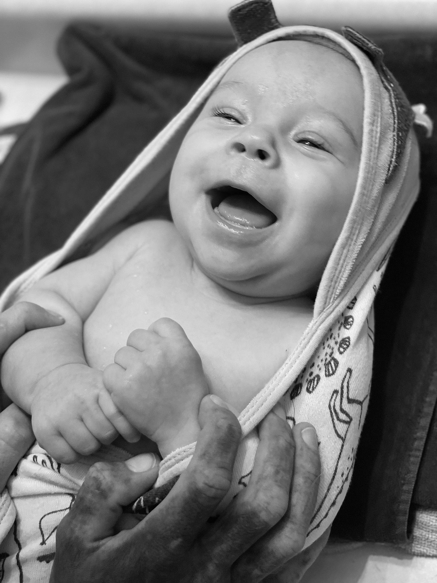 Marvin is registered to the contest to win money with this photo: baby, black, black_and_white, cheek, comfort, eye, eyebrow, finger, gesture, hand, happy, human_body, mouth, person, photograph, skin, smile, style, thumb, toddler