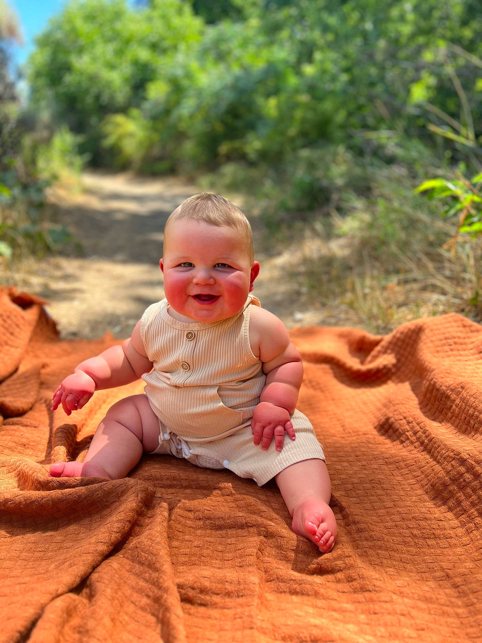 Waylen is registered to the contest to win money with this photo: baby, baby_toddler_clothing, face, finger, grass, happy, joy, landscape, leisure, people_in_nature, person, plant, playing_with_kids, recreation, sand, sitting, sky, smile, summer, toddler