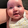Siennarose is registered to the contest to win money with this photo: baby, child, smile, face, eyes, tank_top, white_clothing, yellow_flowers, close_up, person, arm, skin, joyful, cute, infant, portrait, expression, happy, indoors, human