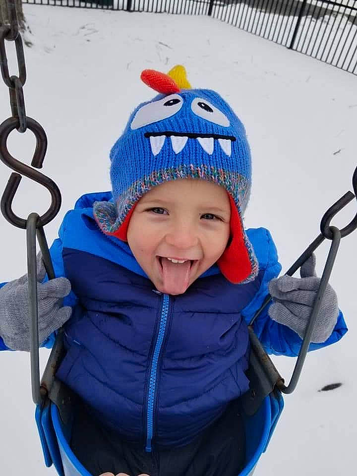 Casen joined the competition — help win amazing prizes! beanie, blue, cap, child, cobalt_blue, electric_blue, headgear, headwear, helmet, joy, outerwear, person, personal_protective_equipment, recreation, smile, snow, swing, toddler, winter