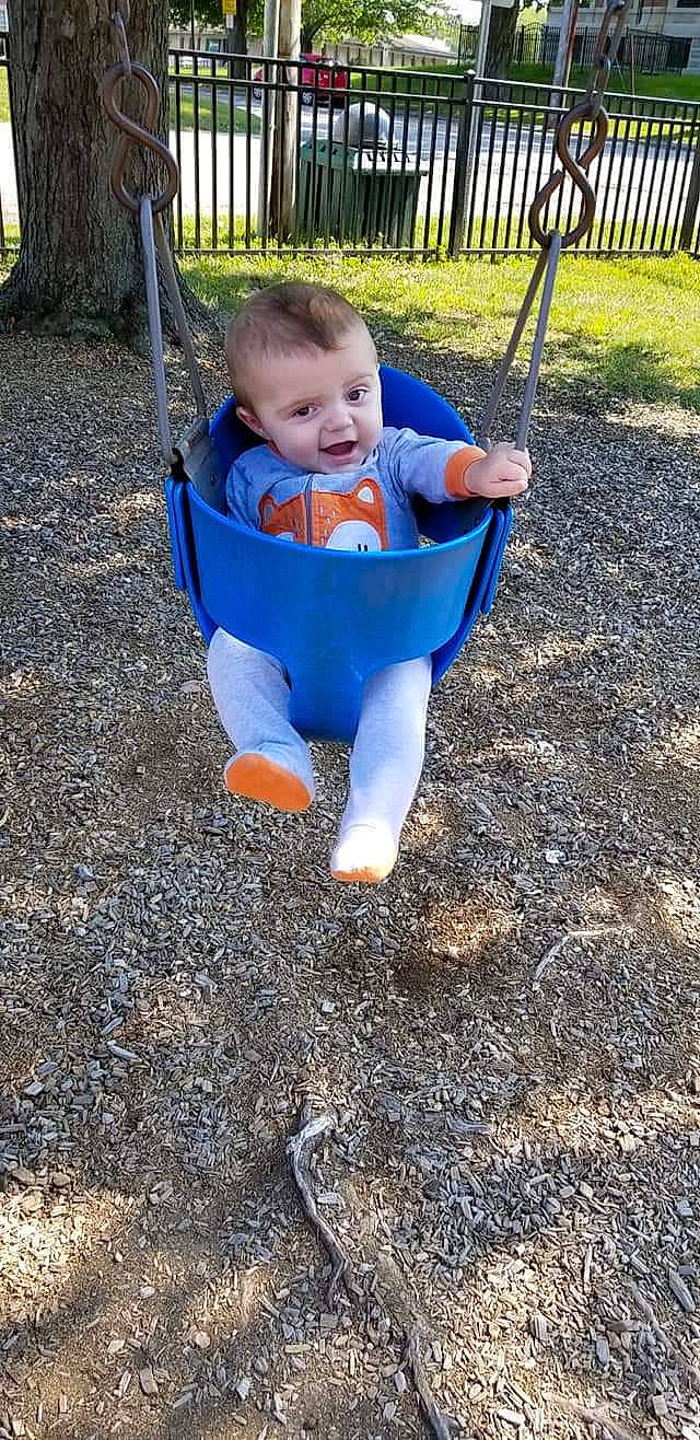 Everett joined the competition — help win amazing prizes! baby, child, fun, human_settlement, outdoor_play_equipment, person, play, playground, product, public_space, smile, soil, swing, toddler, tree