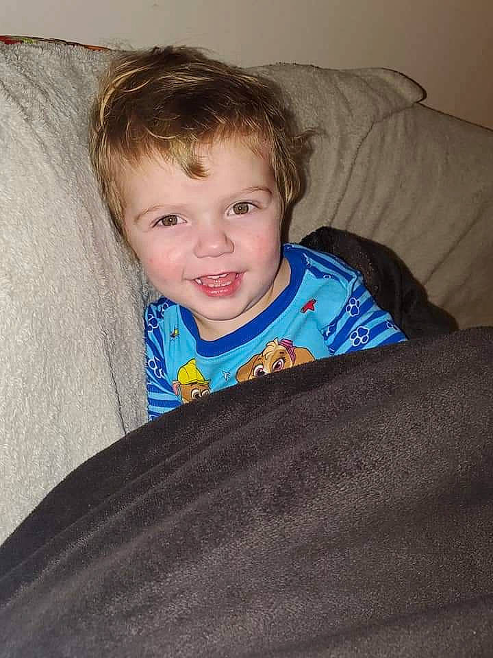 Everett is registered to the contest to win money with this photo: arm, cheek, child, chin, eye, face, forehead, furniture, hair, hairstyle, head, iris, joy, nose, person, sitting, skin, smile, toddler