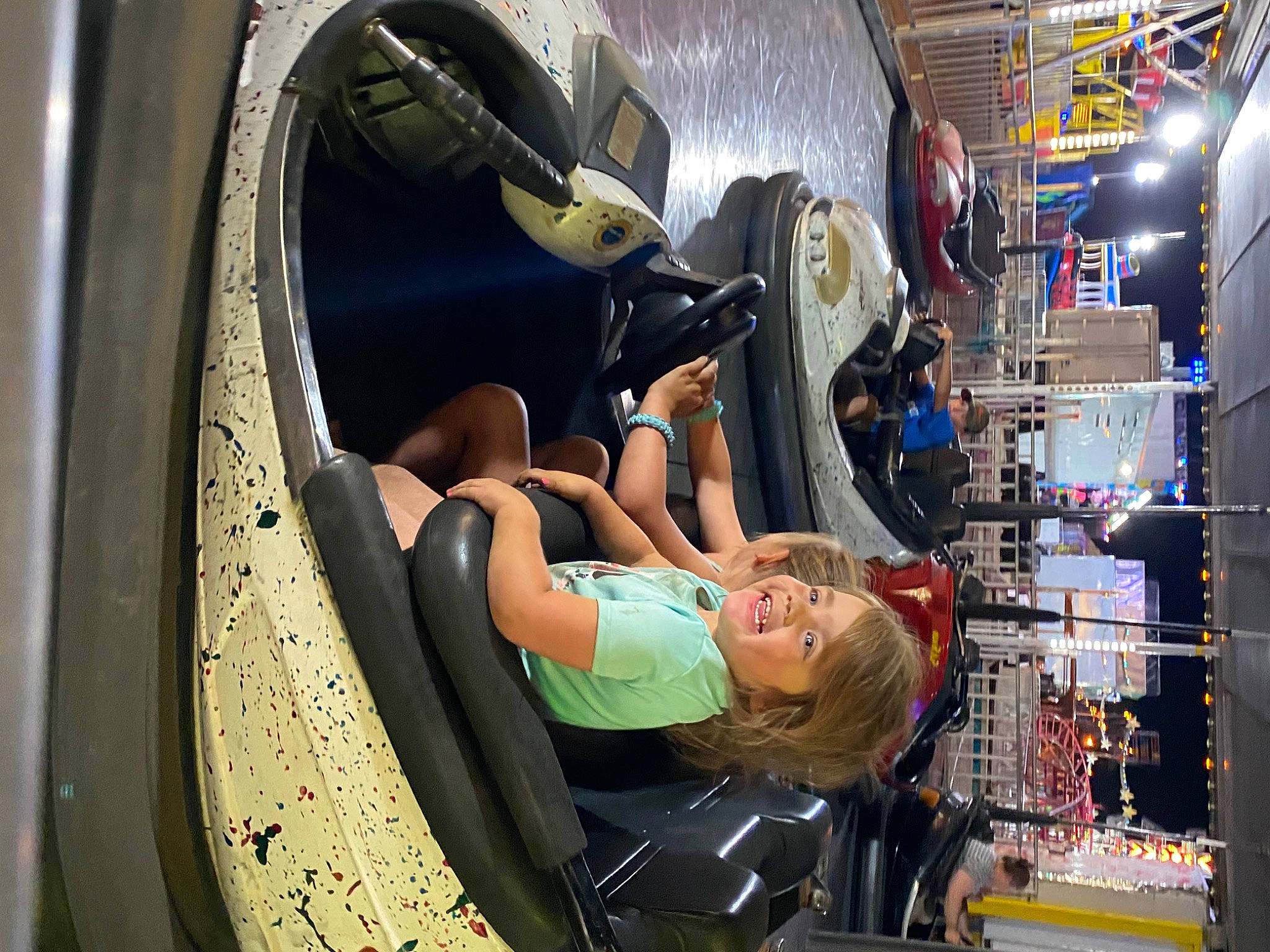 Sophia is registered to the contest to win money with this photo: auto_part, automotive_design, automotive_tire, automotive_wheel_system, circle, city, engineering, eyewear, fun, hat, joy, leisure, machine, motor_vehicle, person, personal_protective_equipment, recreation, t_shirt, tire, vehicle_door