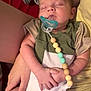 baby, sleeping, pacifier, child, infant, person, hand, arm, clothing, blanket, fabric, beads, comfort, cute, rest, indoor, toddler, skin, holding, peaceful
