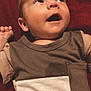Walker is registered to the contest to win money with this photo: baby, infant, child, cute, smiling, looking_up, clothing, onesie, red_background, portrait, face, happy, young, small_hand, skin, head, expression, casual, indoors, closeup