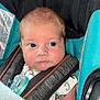 Walker is registered to the contest to win money with this photo: baby, infant, car_seat, blanket, pacifier, clothing, face, head, child, young, seatbelt, safety, curious, indoors, person, portrait, closeup, cute, newborn, expression