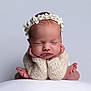 newborn, baby, sleeping, flower_crown, knitted_sweater, hands_under_chin, peaceful, portrait, cute, infant, soft_background, skin, headwear, child, resting, cozy, closeup, baby_feet, adorable, expression