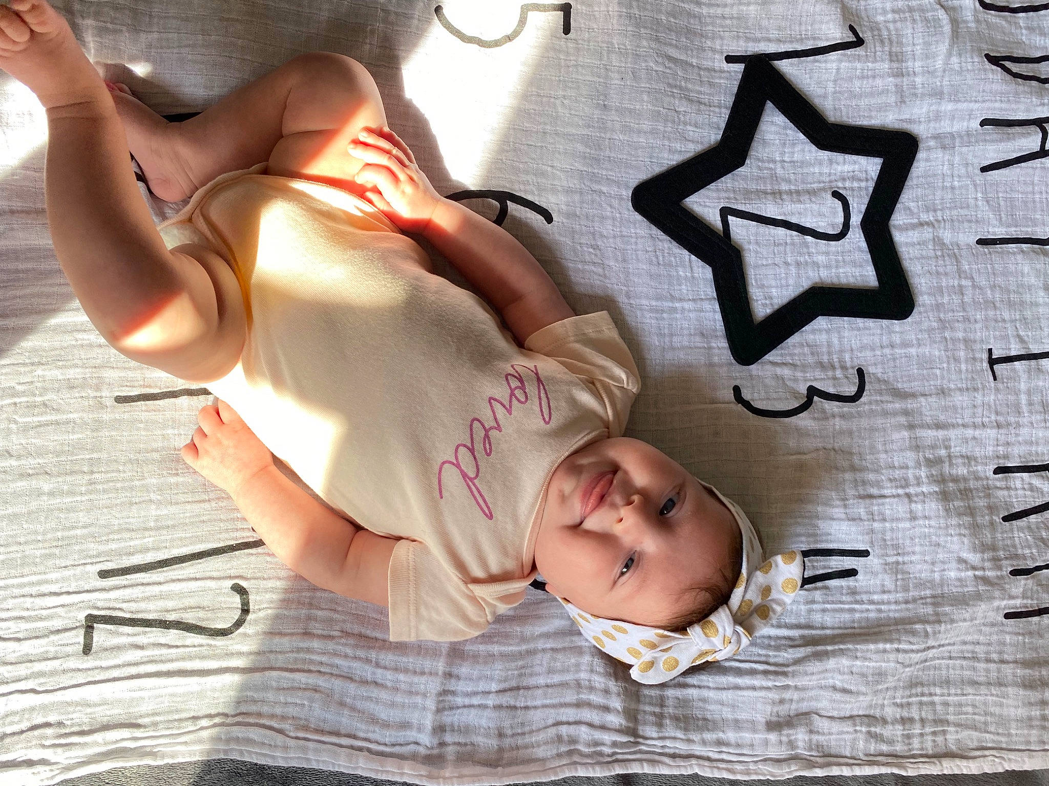 Savannah is registered to the contest to win money with this photo: abdomen, chest, child, comfort, cool, elbow, eyewear, font, foot, fun, gesture, glasses, happy, headwear, human_leg, knee, pattern, person, thigh, trunk
