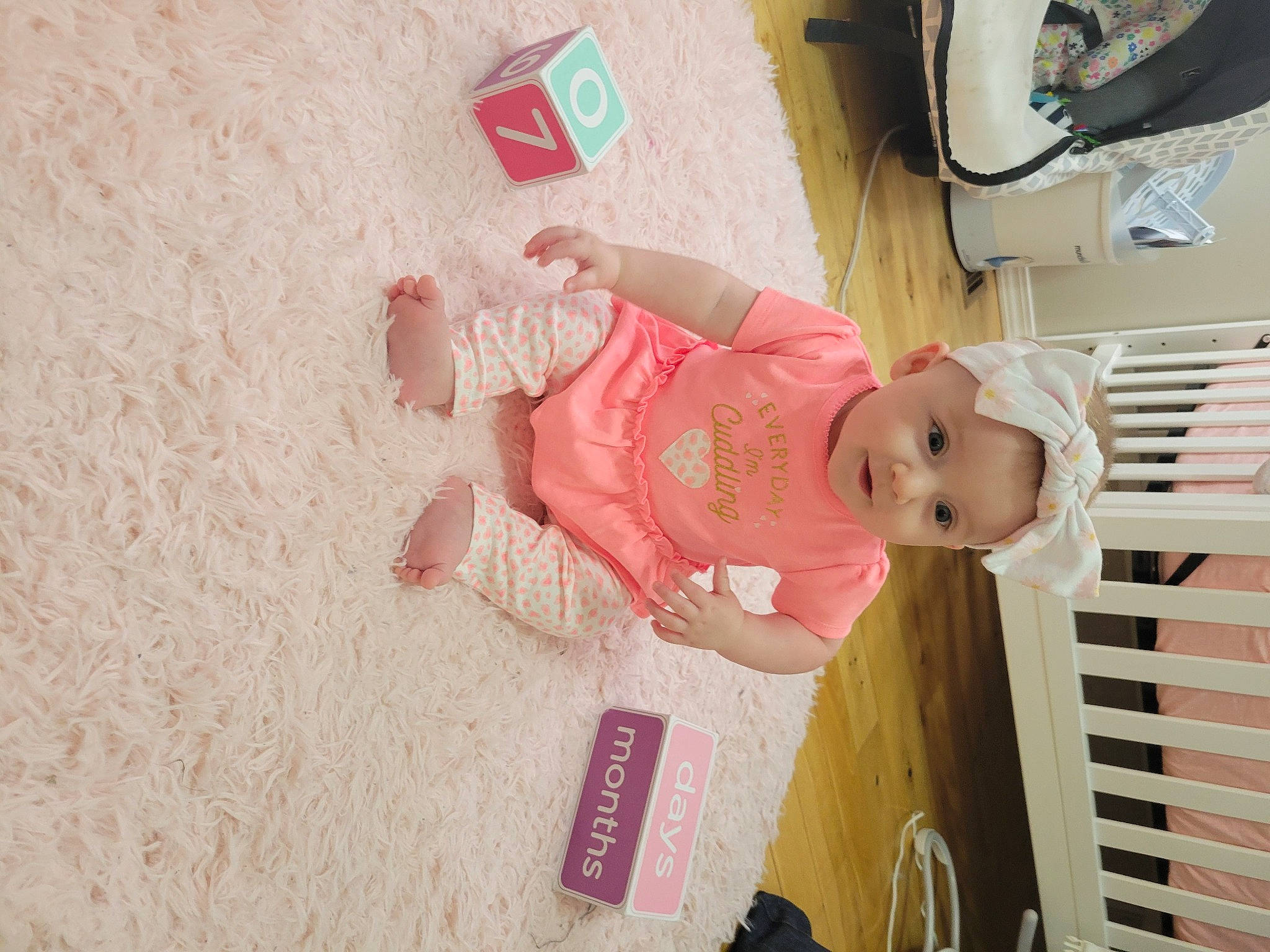 Harper is registered to the contest to win money with this photo: baby, baby_products, baby_toddler_clothing, child, flooring, fun, headwear, magenta, person, pink, room, skin, smile, toddler, vehicle, vehicle_door, wood