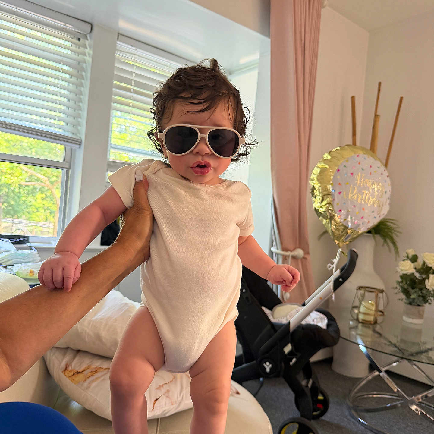 Iker joined the competition — help win amazing prizes! baby, child, sunglasses, hand, indoor, birthday_balloon, flowers, curtains, window, stroller, furniture, person, clothing, light, face, skin, room, decor, celebration, couch