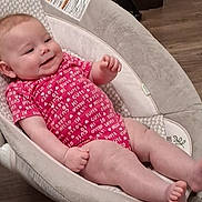 Ivee is registered to the contest to win money with this photo: baby, infant, onesie, pink_clothing, smiling, baby_seat, cushion, face, skin, foot, hand, relaxing, wood_floor, indoor, comfort, child, cute, happy, young, person