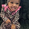baby, child, smiling, tongue_out, leopard_print, headband, pink, black, onesie, socks, sitting, fluffy_blanket, cute, playful, infant, portrait, happy, indoors, person, apparel