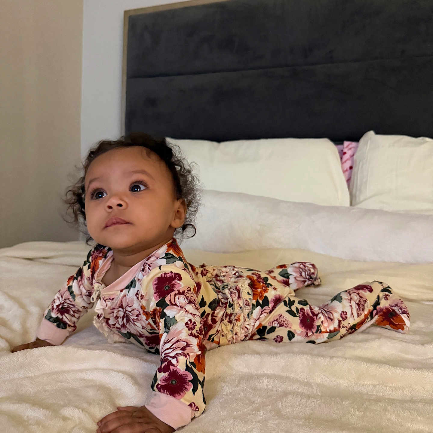 Acelynn joined the competition — help win amazing prizes! baby, child, bed, blanket, pillow, floral_clothing, curly_hair, indoors, portrait, infant, cute, soft_texture, sleepwear, person, young_child, lying_down, comfort, cozy, home, innocence