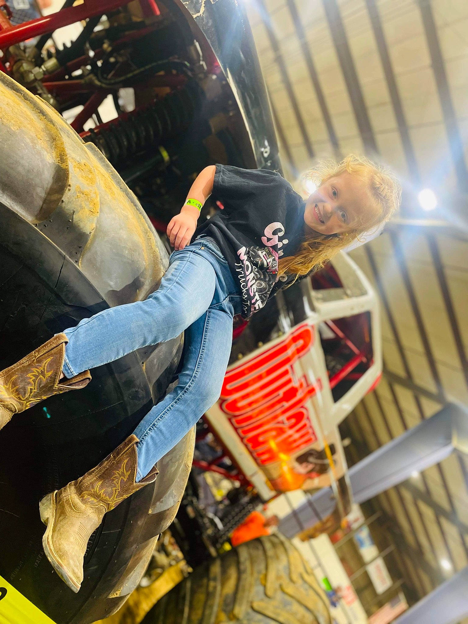 Emma is registered to the contest to win money with this photo: aerospace_engineering, auto_part, automotive_design, automotive_exterior, automotive_tire, belt, bumper, denim, event, flash_photography, human_leg, joy, knee, machine, person, tartan, thigh, transport, workwear