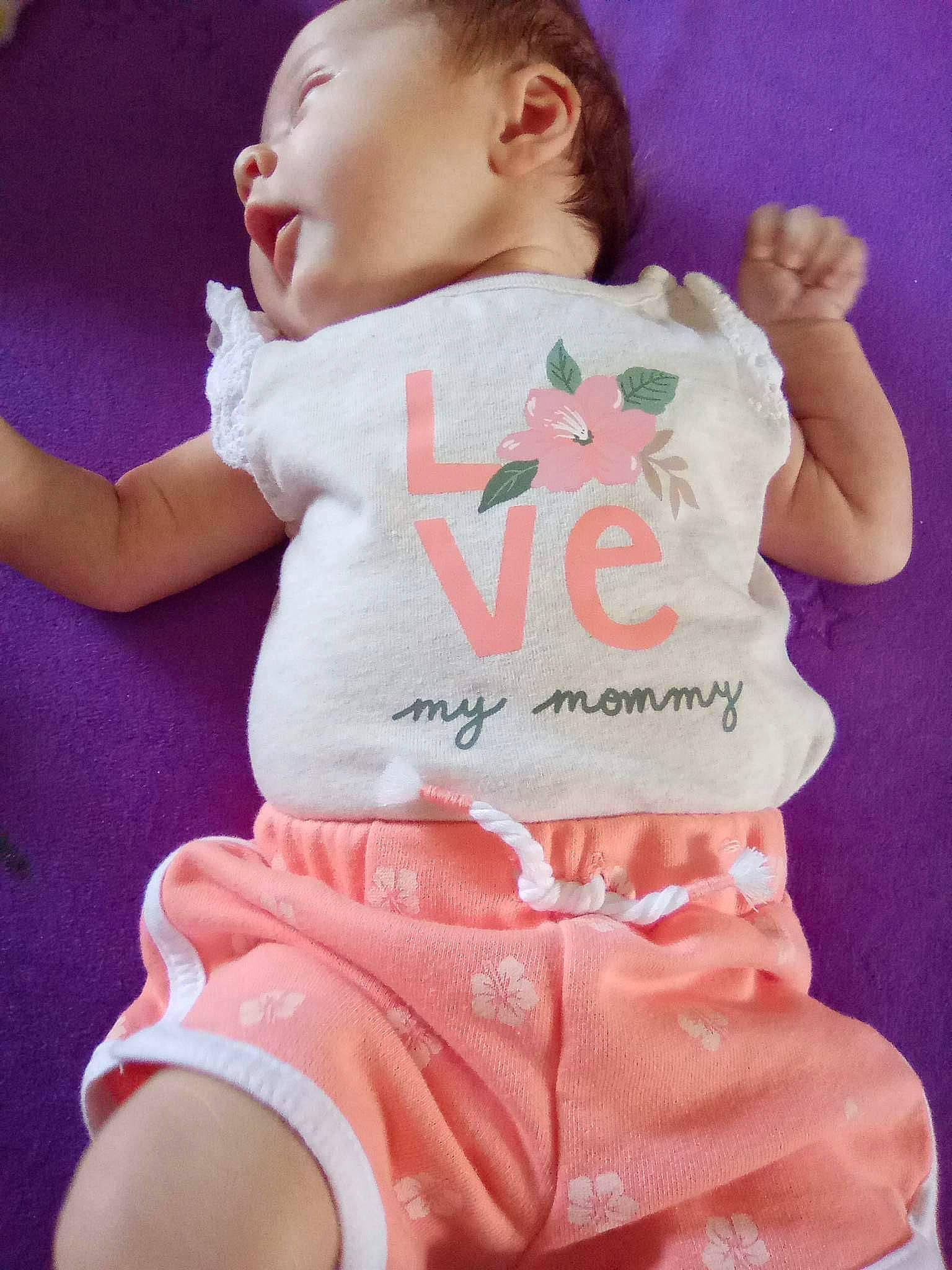 Kelsey is registered to the contest to win money with this photo: baby, baby_toddler_clothing, cheek, child, finger, gesture, hand, happy, head, human_body, human_leg, magenta, neck, person, pink, skin, sleeve, t_shirt, thigh, toddler