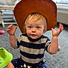 Gunner joined the competition — help win amazing prizes! toddler, child, baby, portrait, smiling, sitting, indoor, hat, cowboy_hat, striped_shirt, star_pattern, blue_eyes, blond_hair, raised_hands, toy, playroom, carpet, window, casual_clothing, happy