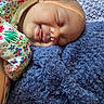baby, sleeping, blanket, blue, floral, onesie, infant, face, peaceful, soft, cozy, child, portrait, closeup, skin, head, rest, comfort, cute, nap