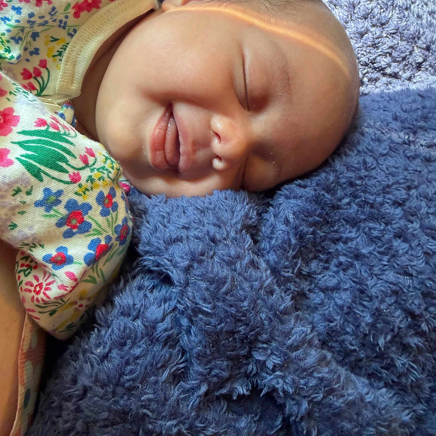 Zeliyana is registered to the contest to win money with this photo: baby, sleeping, blanket, blue, floral, onesie, infant, face, peaceful, soft, cozy, child, portrait, closeup, skin, head, rest, comfort, cute, nap