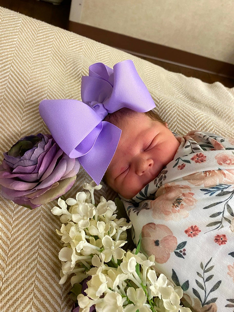 Jordyn is registered to the contest to win money with this photo: artificial_flower, baby_sleeping, bed_sheet, bedding, bouquet, comfort, creative_arts, cut_flowers, floral_design, flower, flower_arranging, flowering_plant, linens, magenta, person, petal, pink, purple, textile, violet