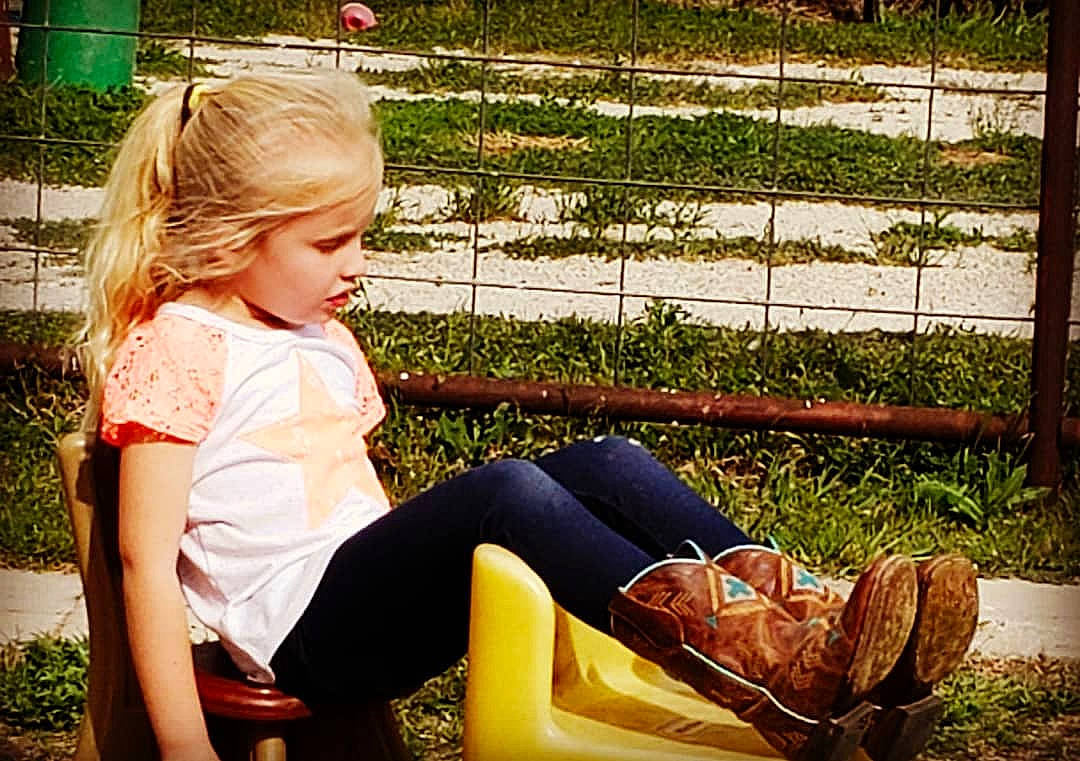 Emily is registered to the contest to win money with this photo: blond, child, footwear, fun, grass, hair, happy, leg, leisure, long_hair, person, photography, plant, shoe, sitting, summer, sunlight, toddler, tree, vacation