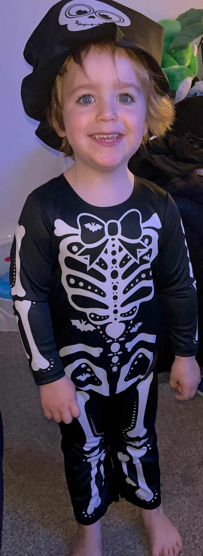 Rory joined the competition — help win amazing prizes! child, costume, skeleton, hat, smile, barefoot, indoor, carpet, cute, happy, halloween, face, person, clothing, black, white, toy, skeleton_costume, childhood, fun