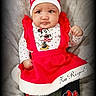 baby, child, infant, red_dress, christmas_hat, minnie_mouse, polka_dot, leggings, white_fur_trim, fluffy_blanket, portrait, sitting, cute, festive, holiday, expression, face, hat, clothing, indoors