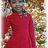 Za'Layah is registered to the contest to win money with this photo: child, girl, red_dress, braids, red_bows, peace_sign, christmas_tree, holiday_decorations, lights, ornaments, smiling, indoor, festive, celebration, portrait, person, happy, seasonal, home, holiday