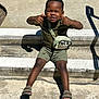 Zaccai joined the competition — help win amazing prizes! child, smiling, outdoor, steps, concrete, shorts, tshirt, sandals, sunlight, shadow, bag, dinosaur, crossbody, playful, happy, person, casual, summer, fashion, portrait