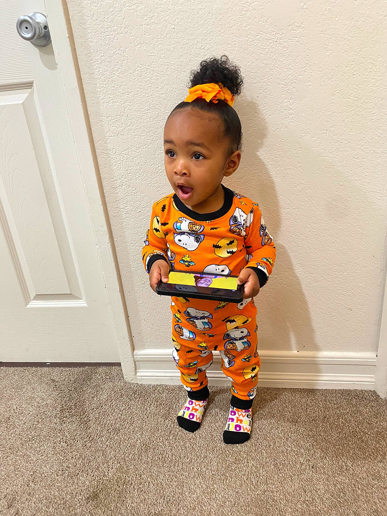 Mykenzie joined the competition — help win amazing prizes! baby, baby_toddler_clothing, child, child_model, costume, door, door_handle, fashion_design, flooring, fun, happy, home_door, human_leg, orange, pattern, person, sleeve, standing, surprise, toddler