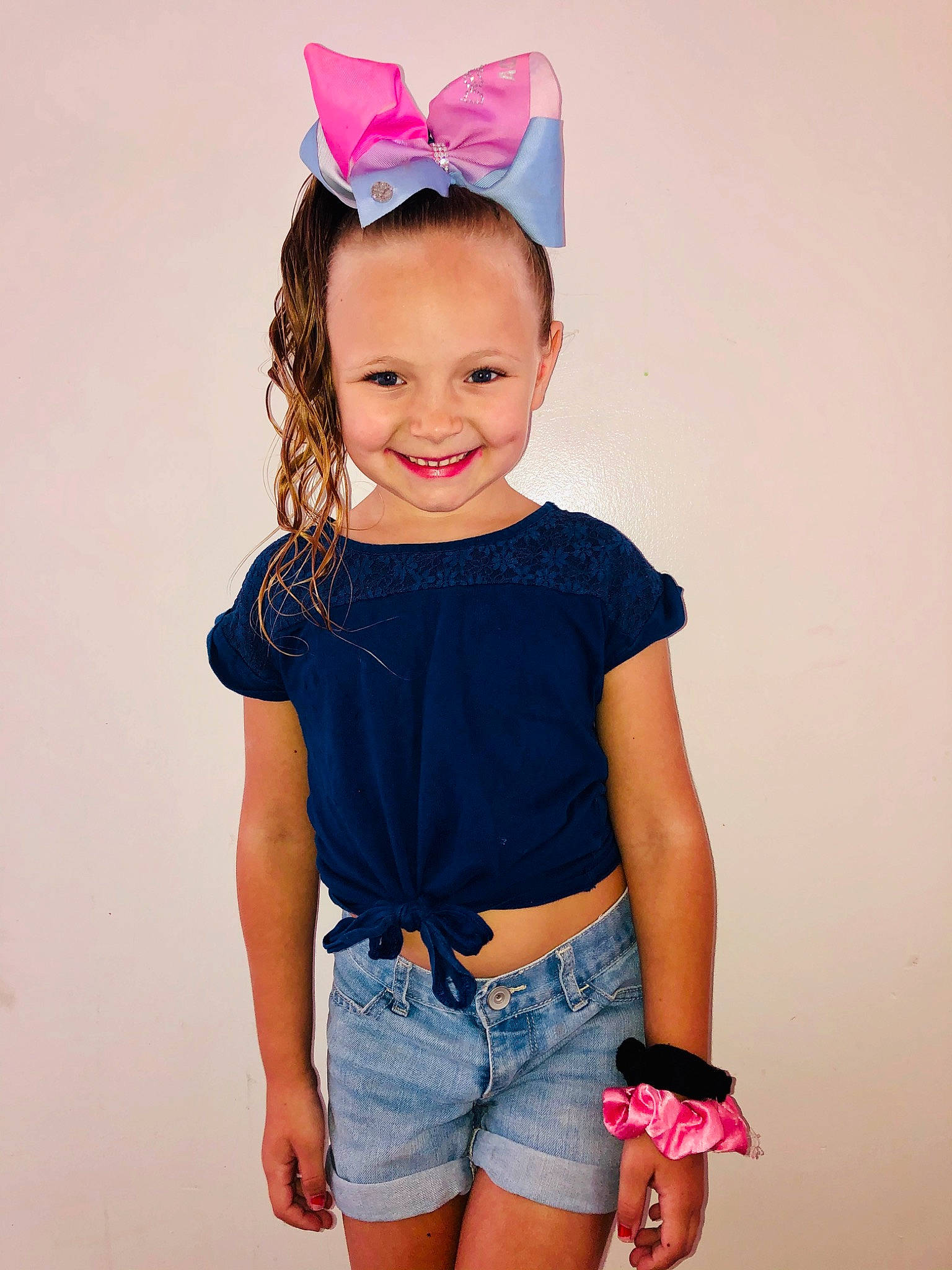 Gracey is registered to the contest to win money with this photo: baby_toddler_clothing, child, child_model, clothing, costume_accessory, denim, hair_accessory, headgear, jeans, joint, joy, neck, person, pink, product, shorts, sleeve, standing, t_shirt, textile