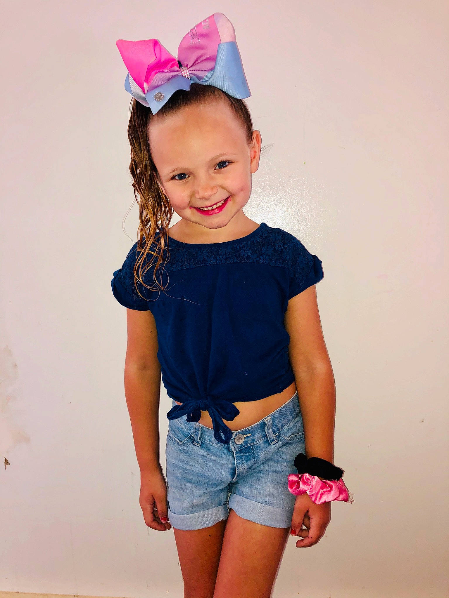 Gracey is registered to the contest to win money with this photo: baby_toddler_clothing, blue, child, child_model, clothing, denim, hair_accessory, headgear, jeans, joint, joy, neck, person, pink, shorts, shoulder, sleeve, t_shirt, textile, toddler