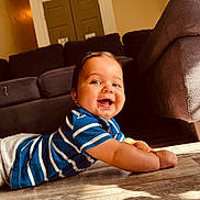 Cedric is registered to the contest to win money with this photo: architecture, baby, babylaughing, bodypart, building, couch, face, furniture, happy, hardwood, head, indoors, livingroom, person, photography, portrait, room, sitting, smile, wood