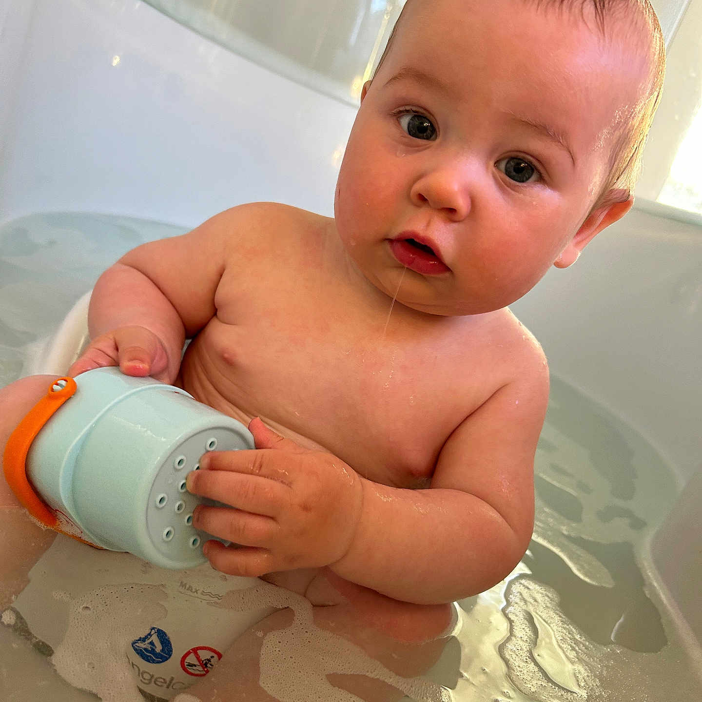 Tobey is registered to the contest to win money with this photo: baby, bathing, bathroom, bathtub, beverage, bodypart, coffee, cup, face, finger, hand, head, indoors, newborn, person, photography, portrait, room, sitting, tub