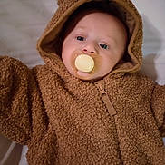 Randal joined the competition — help win amazing prizes! adorable, baby, blue_eyes, brown_onesie, child, closeup, cute, face, fuzzy_clothing, hood, indoors, infant, lying_down, pacifier, portrait, sleepwear, soft_texture, warm_clothing, young_child, zipped_jacket