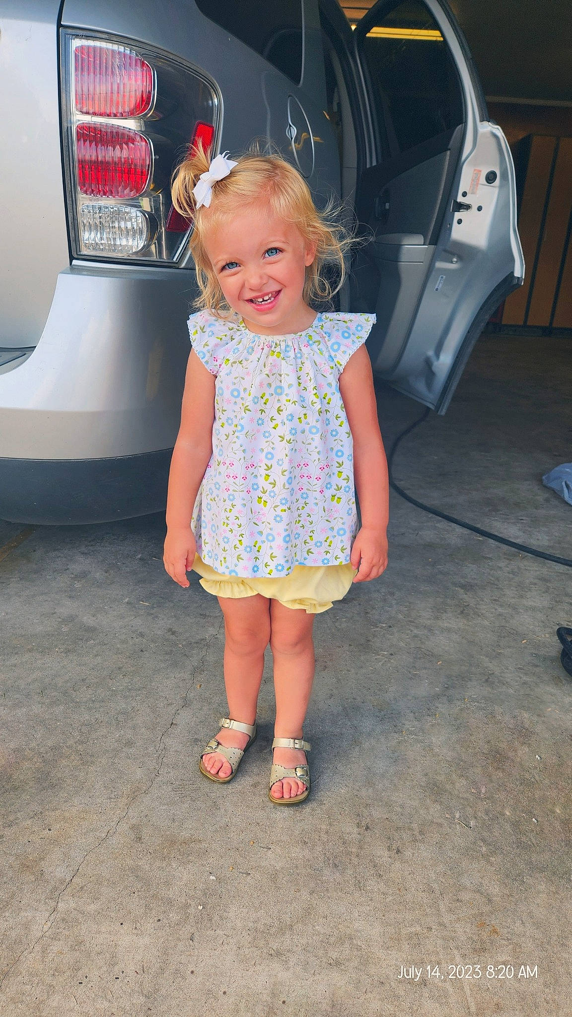 Kollyns is registered to the contest to win money with this photo: automotive_design, automotive_exterior, automotive_lighting, automotive_tail_brake_light, automotive_tire, baby_toddler_clothing, bumper, car, electric_blue, head, human_leg, joy, motor_vehicle, person, pink, product, sandal, smile, toddler, trunk