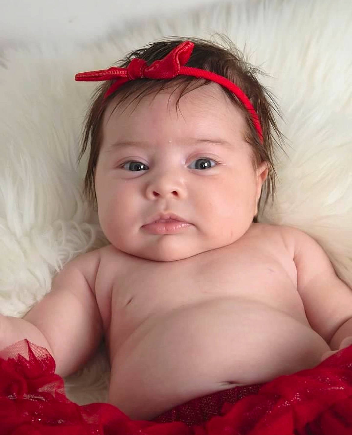 Zora is registered to the contest to win money with this photo: baby, baby_toddler_clothing, cheek, child, chin, close_up, comfort, eyelash, flash_photography, fun, happy, iris, linens, lip, mouth, person, pink, red, skin, smile