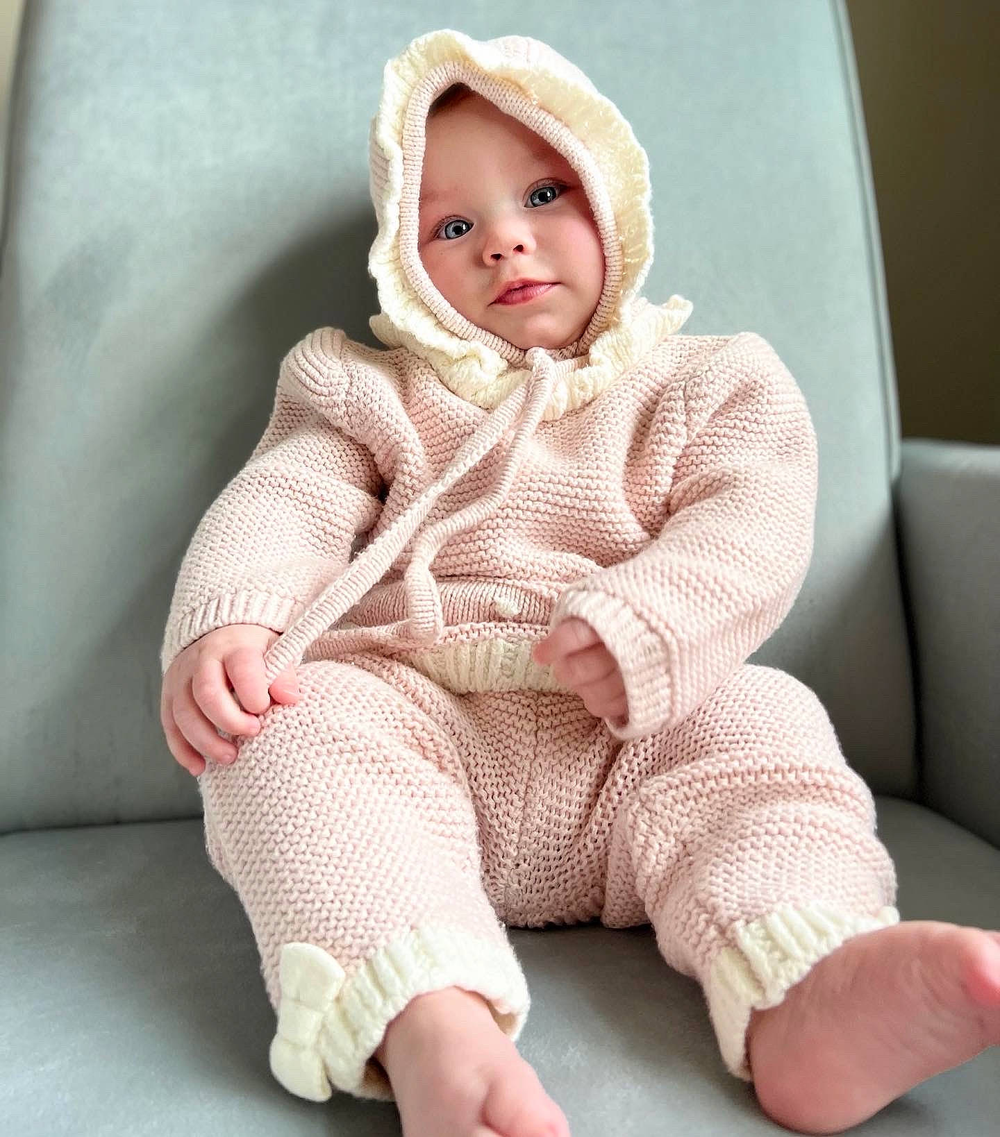 Svannah joined the competition — help win amazing prizes! arm, baby, baby_toddler_clothing, cheek, child, collar, comfort, dress, face, foot, headgear, headwear, human_body, human_leg, knee, outerwear, pattern, person, sitting, skin