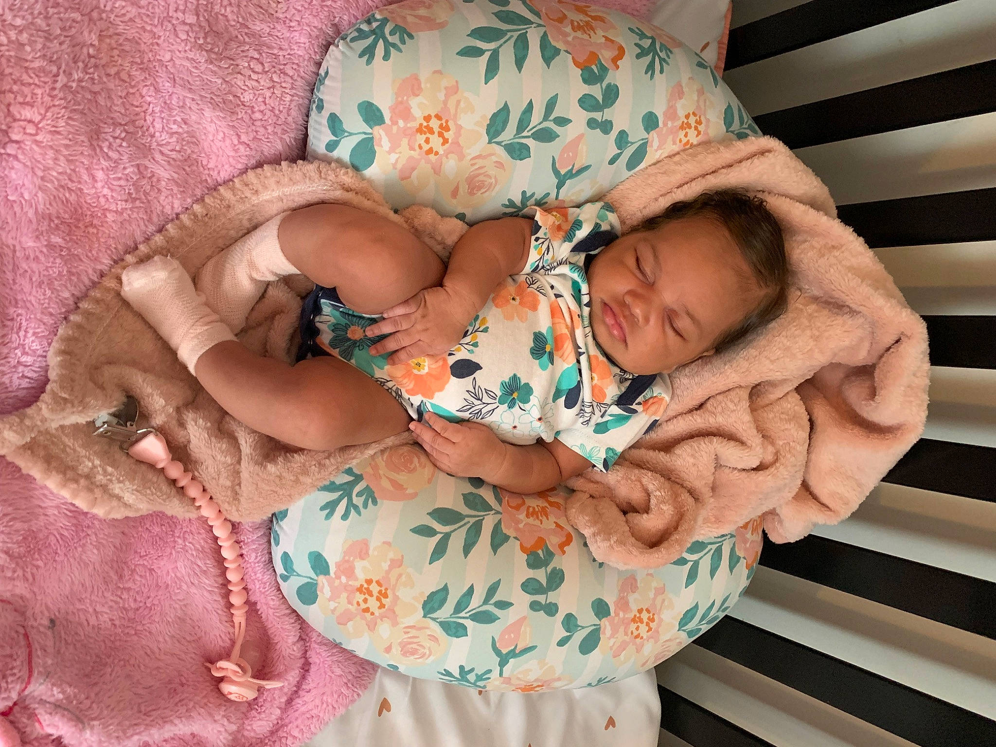 Ariya is registered to the contest to win money with this photo: arm, baby, baby_products, baby_sleeping, baby_toddler_clothing, comfort, eye, face, finger, glasses, hand, head, human_body, linens, pattern, person, pink, skin, sleeve, textile